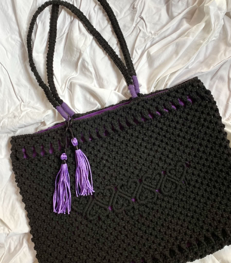A shiek detailed macrame black shoulder bag with decorative heart patterns and inside bag lining